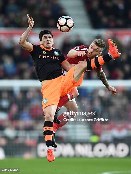 Fernando Forestieri of Sheffield Wednesday and Adam Clayton of Middlesbrough battle to win a header during The Emirates FA Cup Third Round match...