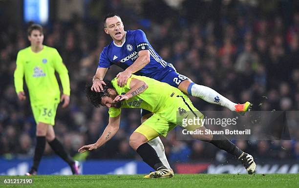 John Terry of Chelsea fouls Michael Bostwick of Peterborough United during The Emirates FA Cup Third Round match between Chelsea and Peterborough...