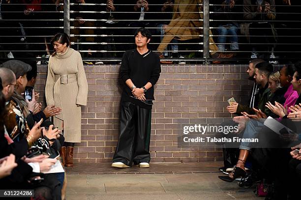 Designer Mihara Yasuhiro salutes the crowd following the Maison MIHARA YASUHIRO show during London Fashion Week Men's January 2017 collections at...