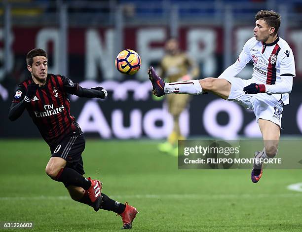 Milan's midfielder of Croatia Mario Paalic vies with Cagliari defender of Italy Nicolo Barella during the Italian Serie A football match AC Milan vs...
