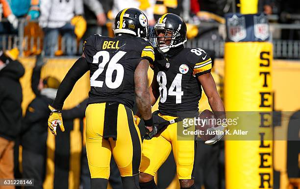 Antonio Brown of the Pittsburgh Steelers celebrates his touchdown with Le'Veon Bell in the first quarter during the Wild Card Playoff game against...