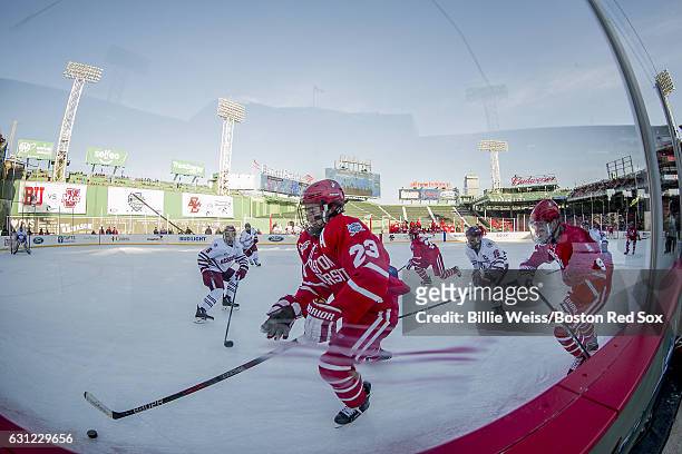 Jacob Forsbacka Karlsson of Boston University handles the buck before scoring a goal during the first period of a Frozen Fenway game against the...