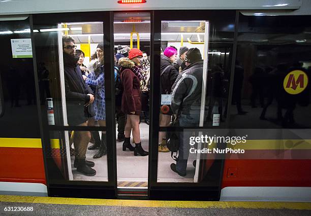 People without pants ride an underground train on January 8, 2017 in Warsaw, Poland. The annual event, called 'No Pants Day,' is a whimsical Facebook...
