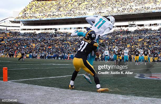 DeVante Parker of the Miami Dolphins is knocked out of bounds by Ross Cockrell of the Pittsburgh Steelers while attempting a two point conversion in...