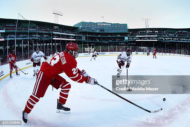 Steven Iacobellis of the Massachusetts Minutemen defends Jakob Forsbacka Karlsson of the Boston University Terriers at Fenway Park on January 8, 2017...