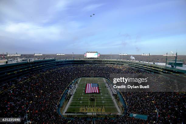 Two F-18 fighter jets fly over the stadium during the national anthem before the NFC Wild Card game between the Green Bay Packers and the New York...