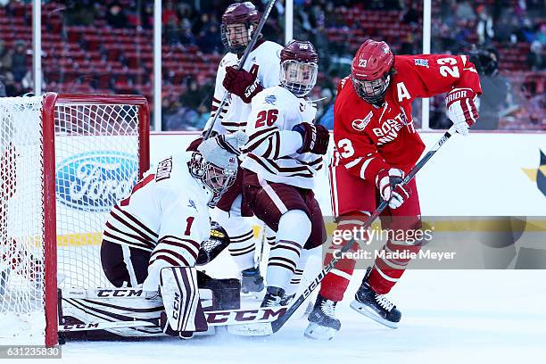 Jakob Forsbacka Karlsson of the Boston University Terriers scores against Ryan Wischow of the Massachusetts Minutemen with pressure from Joseph...