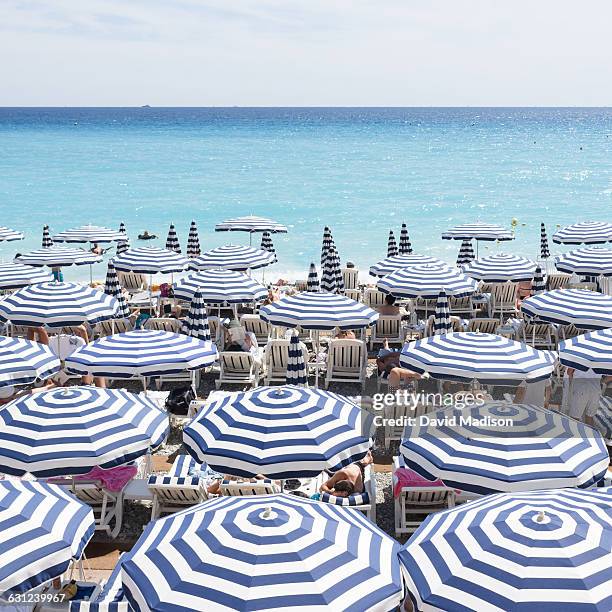 umbrellas on the french riviera - beach umbrella stock pictures, royalty-free photos & images