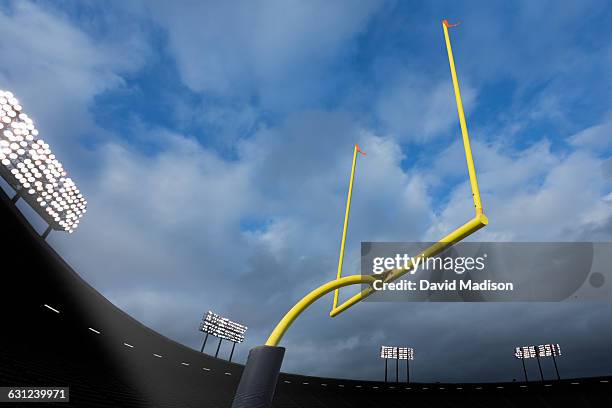 football goal posts in stadium - lumière de stade ou de chantier photos et images de collection