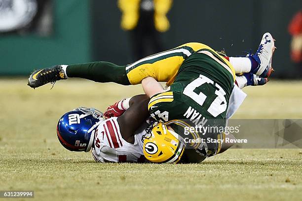 Jake Ryan of the Green Bay Packers tackles Bobby Rainey of the New York Giants in the second quarter during the NFC Wild Card game at Lambeau Field...