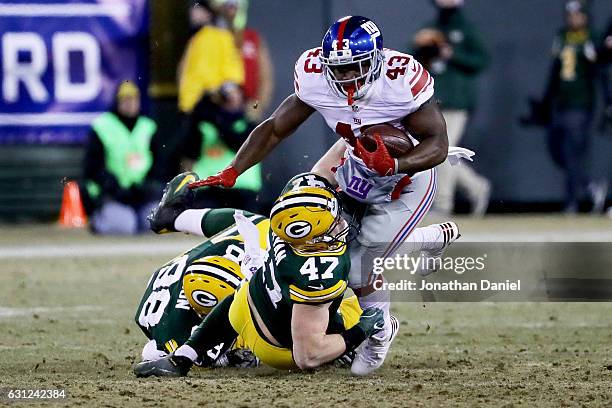 Jake Ryan of the Green Bay Packers tackles Bobby Rainey of the New York Giants in the second quarter during the NFC Wild Card game at Lambeau Field...