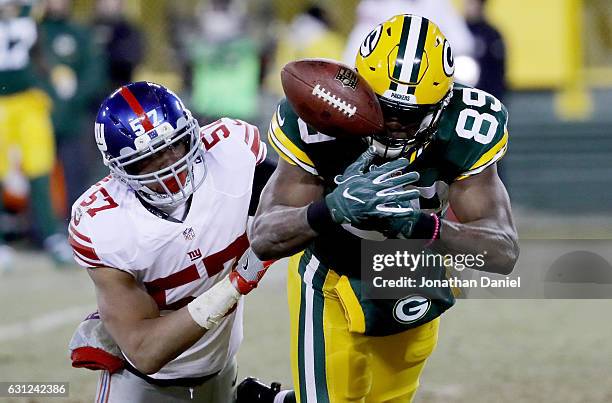 Jared Cook of the Green Bay Packers fails to make a catch while being guarded by Keenan Robinson of the New York Giants in the second quarter during...