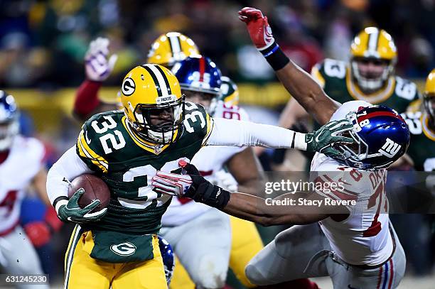 Christine Michael of the Green Bay Packers fends off a tackle attempt by Romeo Okwara of the New York Giants in the third quarter during the NFC Wild...