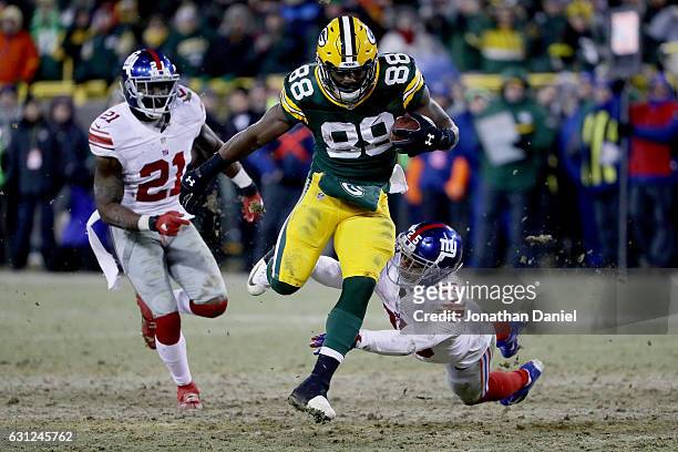 Ty Montgomery of the Green Bay Packers escapes a tackle attempt by Leon Hall of the New York Giants in the fourth quarter during the NFC Wild Card...