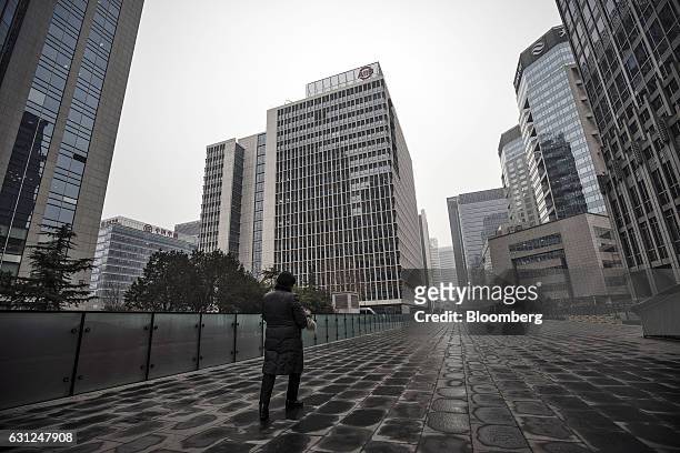 Pedestrian walks towards the Asian Infrastructure Investment Bank headquarters building in Beijing, China, on Thursday, Jan. 5 2017. One year after...