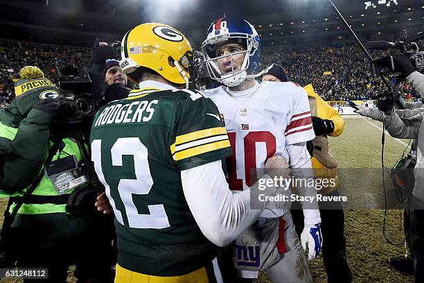 Aaron Rodgers of the Green Bay Packers and Eli Manning of the New York Giants meet after the Green Bay Packers beat the New York Giants 38-31 in the...