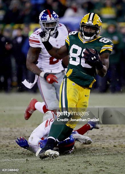 Ty Montgomery of the Green Bay Packers escapes a tackle attempt by Leon Hall of the New York Giants in the fourth quarter during the NFC Wild Card...