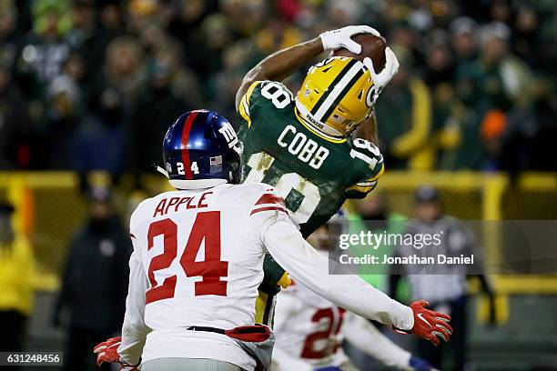 Randall Cobb of the Green Bay Packers catches a touchdown pass while being guarded by Eli Apple of the New York Giants in the fourth quarter during...