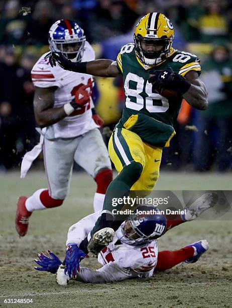 Ty Montgomery of the Green Bay Packers escapes a tackle attempt by Leon Hall of the New York Giants in the fourth quarter during the NFC Wild Card...