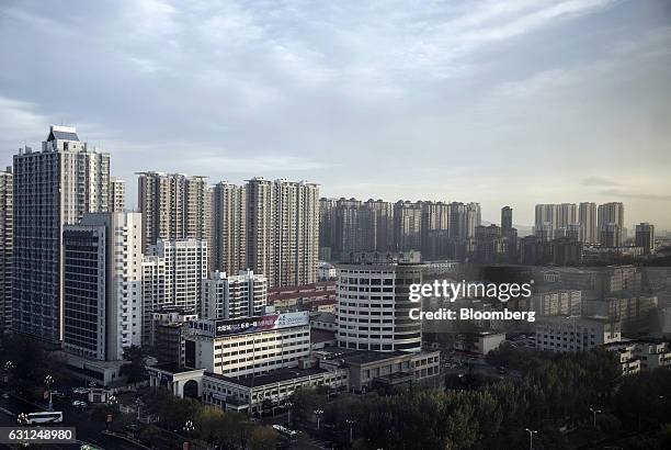 Residential buildings stand in Qinhuangdao, Hebei province, China, on Friday, Oct. 28, 2016. China's top overseas bond fund said Chinese property...