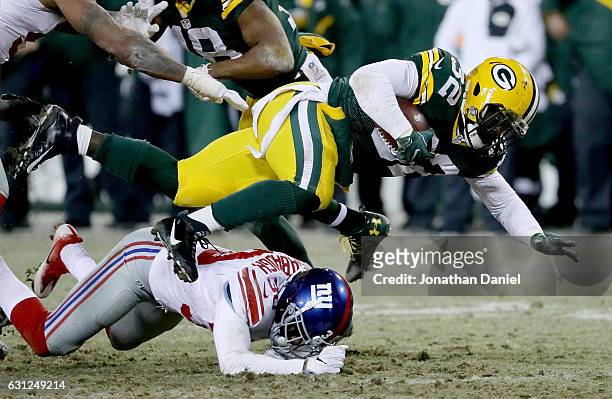 Coty Sensabaugh of the New York Giants tackles Christine Michael of the Green Bay Packers in the fourth quarter during the NFC Wild Card game at...