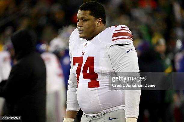 Ereck Flowers of the New York Giants walks off the field after losing to the Green Bay Packers 38-13 in the NFC Wild Card game at Lambeau Field on...