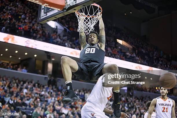 John Collins of the Wake Forest Demon Deacons dunks the ball over Mamadi Diakite of the Virginia Cavaliers at John Paul Jones Arena on January 8,...