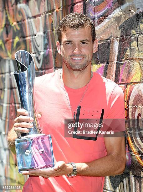 Grigor Dimotrov poses with the Men's 2017 Brisbane International winners trophy at Chur Burger on January 9, 2017 in Brisbane, Australia.