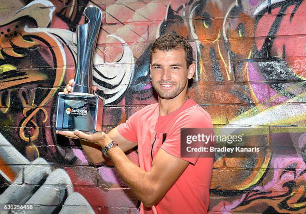 Grigor Dimotrov poses with the Men's 2017 Brisbane International winners trophy at Chur Burger on January 9, 2017 in Brisbane, Australia.