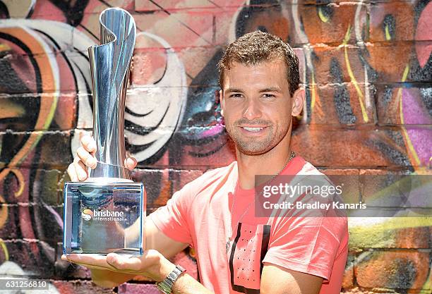 Grigor Dimotrov poses with the Men's 2017 Brisbane International winners trophy at Chur Burger on January 9, 2017 in Brisbane, Australia.