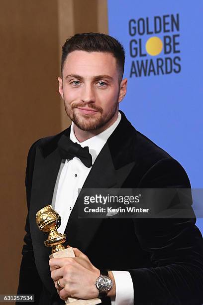 Actor Aaron Taylor-Johnson, winner of Best Supporting Actor in a Motion Picture for 'Nocturnal Animals,' poses in the press room during the 74th...