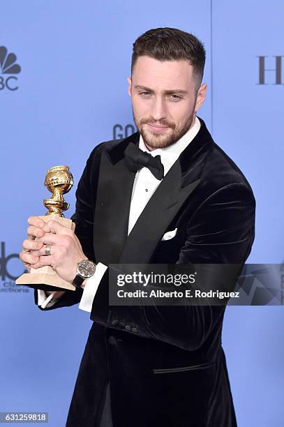 Actor Aaron Taylor-Johnson, winner of Best Performance by an Actor in a Supporting Role for 'Nocturnal Animals', poses in the press room during the...