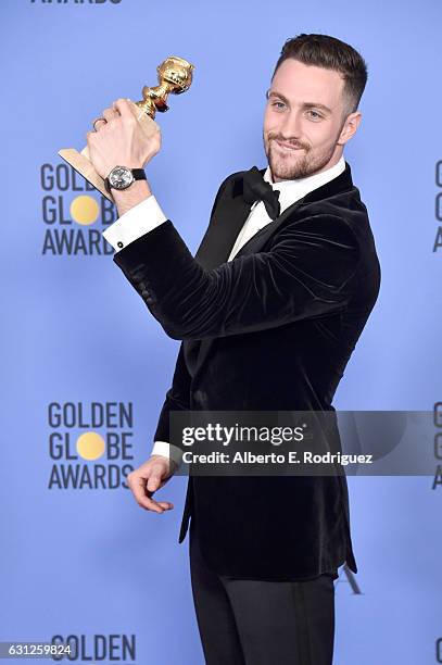 Actor Aaron Taylor-Johnson, winner of Best Performance by an Actor in a Supporting Role for 'Nocturnal Animals', poses in the press room during the...