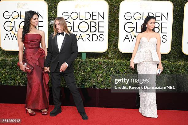 74th ANNUAL GOLDEN GLOBE AWARDS -- Pictured: Nina Alu, musician Iggy Pop and actress Praya Lundberg arrive to the 74th Annual Golden Globe Awards...