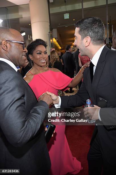 Actors Courtney B. Vance , Angela Bassett and David Schwimmer at the 74th annual Golden Globe Awards sponsored by FIJI Water at The Beverly Hilton...