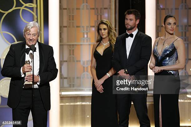 In this handout photo provided by NBCUniversal, director Paul Verhoeven accepts the award for Best Foreign Language Film for "Elle" during the 74th...