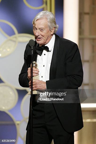 In this handout photo provided by NBCUniversal, director Paul Verhoeven accepts the award for Best Foreign Language Film for "Elle" during the 74th...