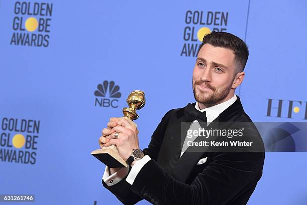 Actor Aaron Taylor-Johnson, winner of Best Supporting Actor in a Motion Picture for 'Nocturnal Animals,' poses in the press room during the 74th...