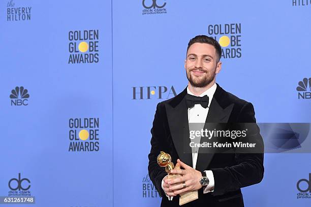 Actor Aaron Taylor-Johnson, winner of Best Supporting Actor in a Motion Picture for 'Nocturnal Animals,' poses in the press room during the 74th...