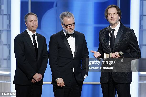 In this handout photo provided by NBCUniversal, producer Clark Spencer and directors Rich Moore and Byron Howard accept the award for Best Motion...