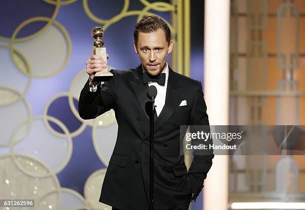 In this handout photo provided by NBCUniversal, Tom Hiddleston accepts the award for Best Actor - Limited Series or Motion Picture for TV for his...