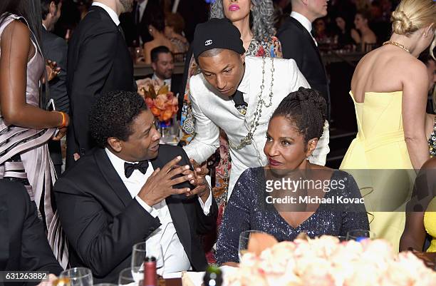 Actor Denzel Washington, singer Pharrell Williams, and Pauletta Washington attend the 74th Annual Golden Globe Awards at The Beverly Hilton Hotel on...