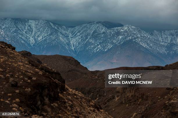 Volcanic desert landscape is seen with snowy Eastern Sierra Nevada Mountains in the distance near Lone Pine, California, January 8, 2017 as a series...