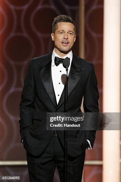 In this handout photo provided by NBCUniversal, presenter Brad Pitt onstage during the 74th Annual Golden Globe Awards at The Beverly Hilton Hotel on...