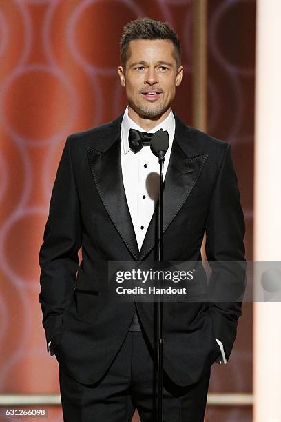 In this handout photo provided by NBCUniversal, presenter Brad Pitt onstage during the 74th Annual Golden Globe Awards at The Beverly Hilton Hotel on...
