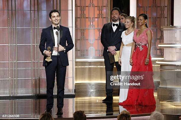 In this handout photo provided by NBCUniversal, Damien Chazelle accepts the award for Best Director - Motion Picture for " La La Land" onstage during...