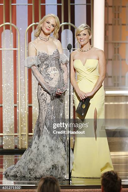 In this handout photo provided by NBCUniversal, presenters Nicole Kidman and Reese Witherspoon onstage during the 74th Annual Golden Globe Awards at...