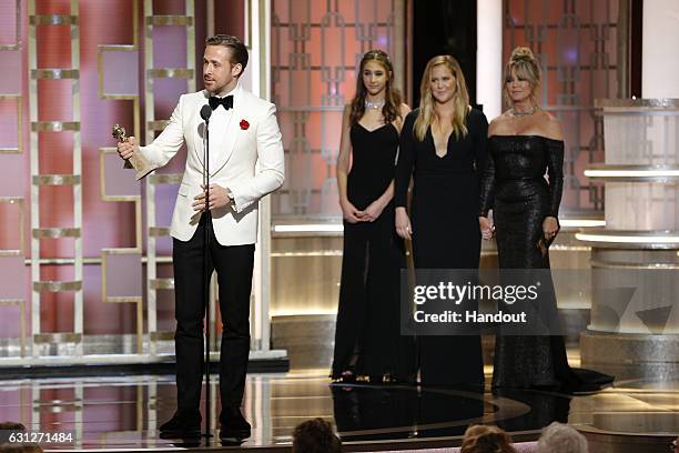 In this handout photo provided by NBCUniversal, Ryan Gosling accepts the award for Best Actor in a Motion Picture - Musical or Comedy for his role in...