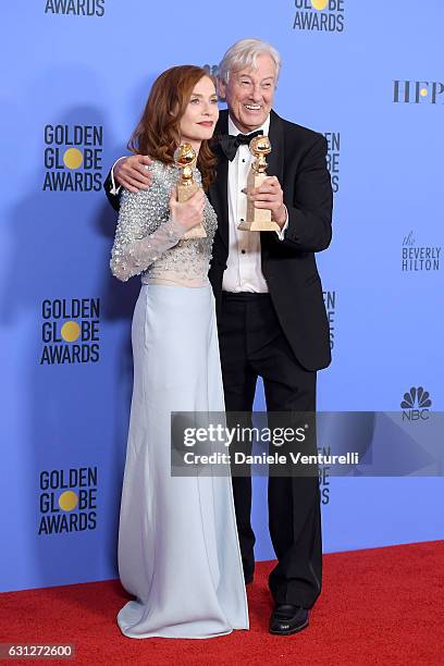 Actress Isabelle Huppert and filmmaker Paul Verhoeven pose in the press room during the 74th Annual Golden Globe Awards at The Beverly Hilton Hotel...