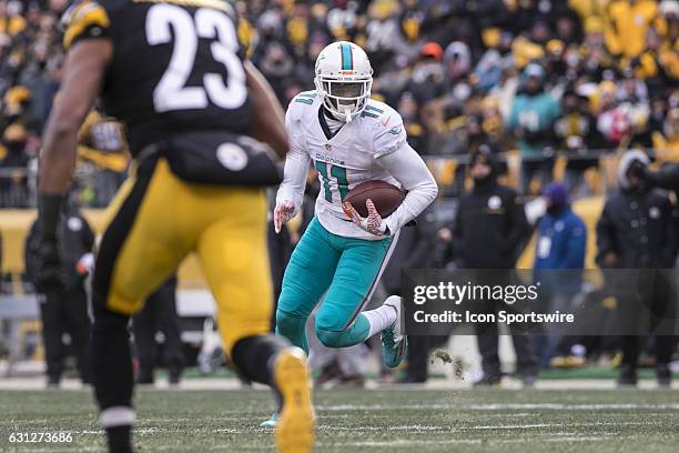 Miami Dolphins wide receiver DeVante Parker runs with the ball after making a catch during the NFL Football Wild Card Playoff game between the Miami...